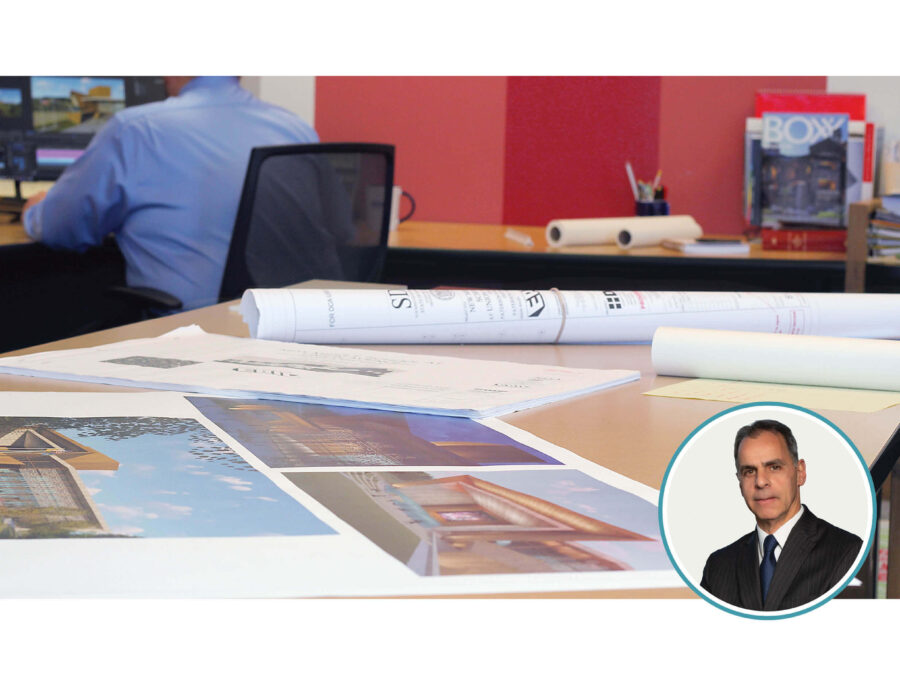 Architectural plans on a desk and the author's photo.
