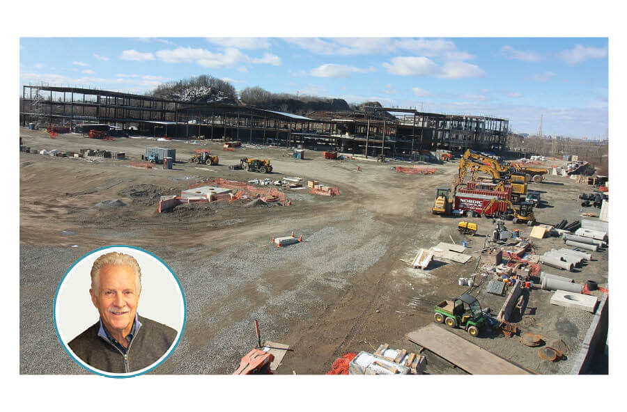 A large building, several hundred thousand square feet in size, under construction. The author's photo is also included.