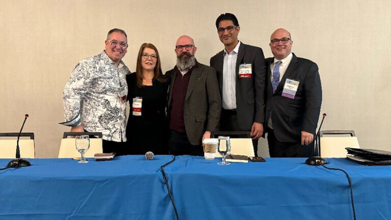 A group photo of the four panelists and moderator on the construction and design panel.
