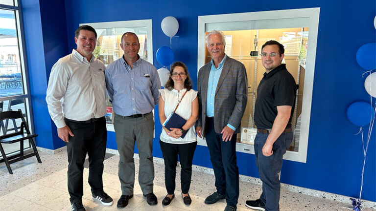 Members of the DMR Architects team pose in the lobby of the Blanquita B. Valenti Community School at the ribbon cutting event.