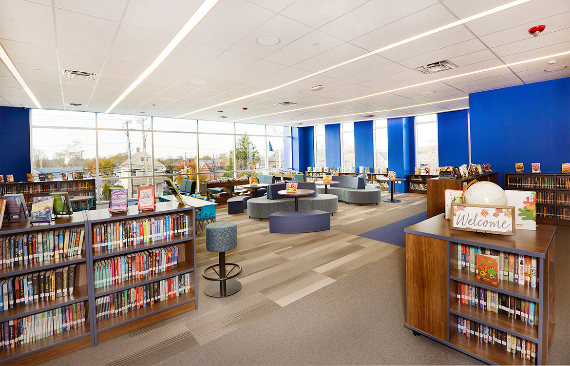 The media center at Blanquita B. Valenti Community School features large glass windows that wraparound the space.