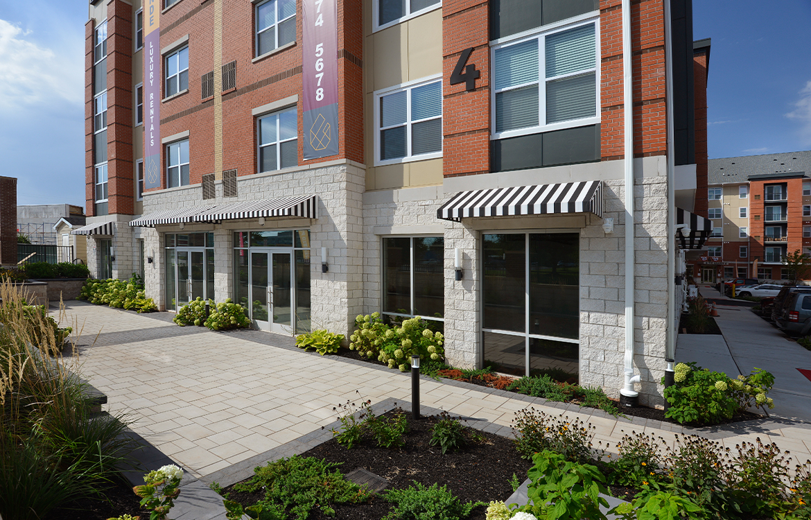 The exterior, ground level of Building 4 which shows storefronts for future retail tenants.