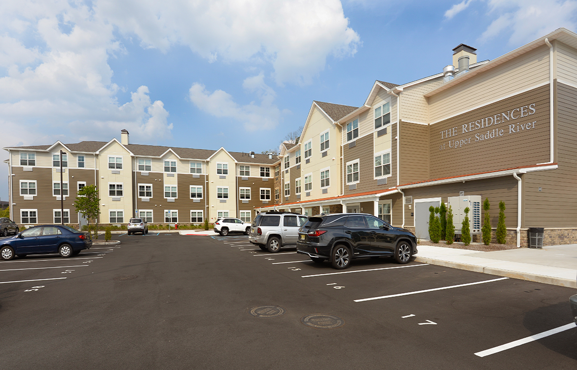 The exterior of The Residences at Upper Saddle River, which also shows the parking.