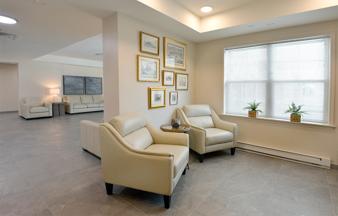 Two chairs in a small gathering area for residents at The Residences at Upper Saddle River, demonstrating the variety of gathering and socialization options.